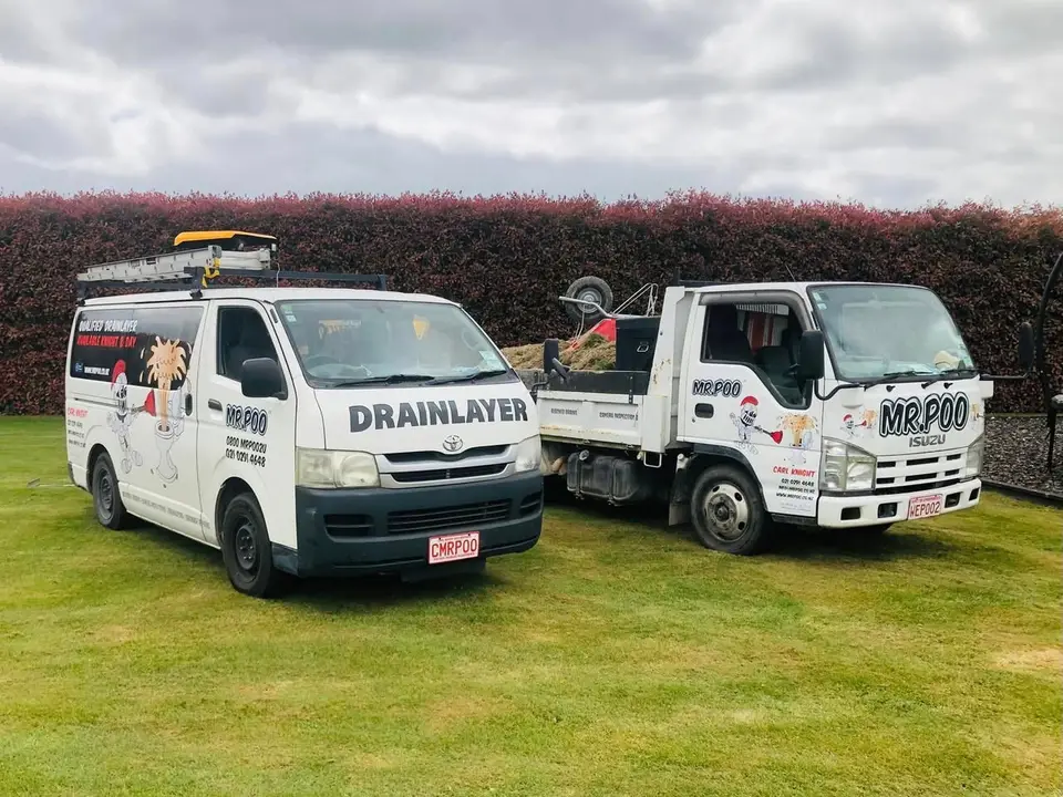 The Mr Poo Drainage van and tip truck parked up, both in full branding